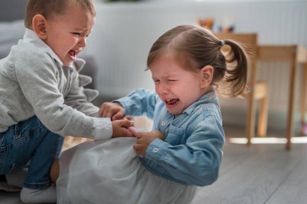 Two kids fight for a toy