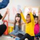 Kid raising their hands in in class