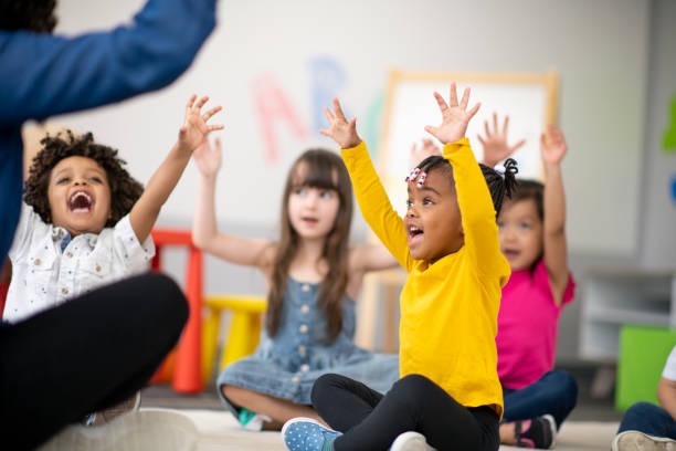 Kid raising their hands in in class