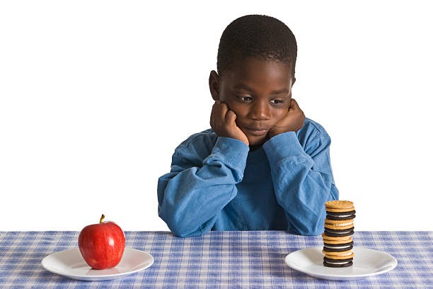 a kid picking which snack he want to eat