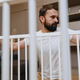 Father checking a baby gate inside his home 