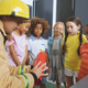 Firefighter teaching a group of preschool children about fire safety