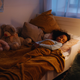 A young child sleeping peacefully in her own bed at night 